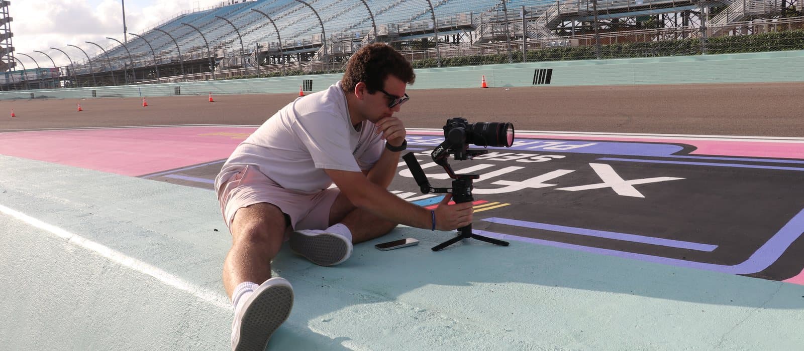An AL Media Group videographer filming with a gimbal rig at Homestead-Miami Speedway